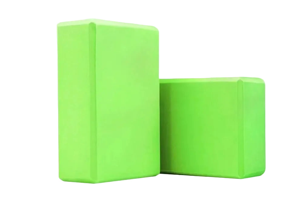 Two green yoga blocks on a white background