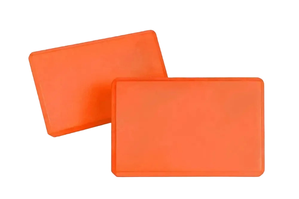 Two orange Yoga Blocks on a white background.