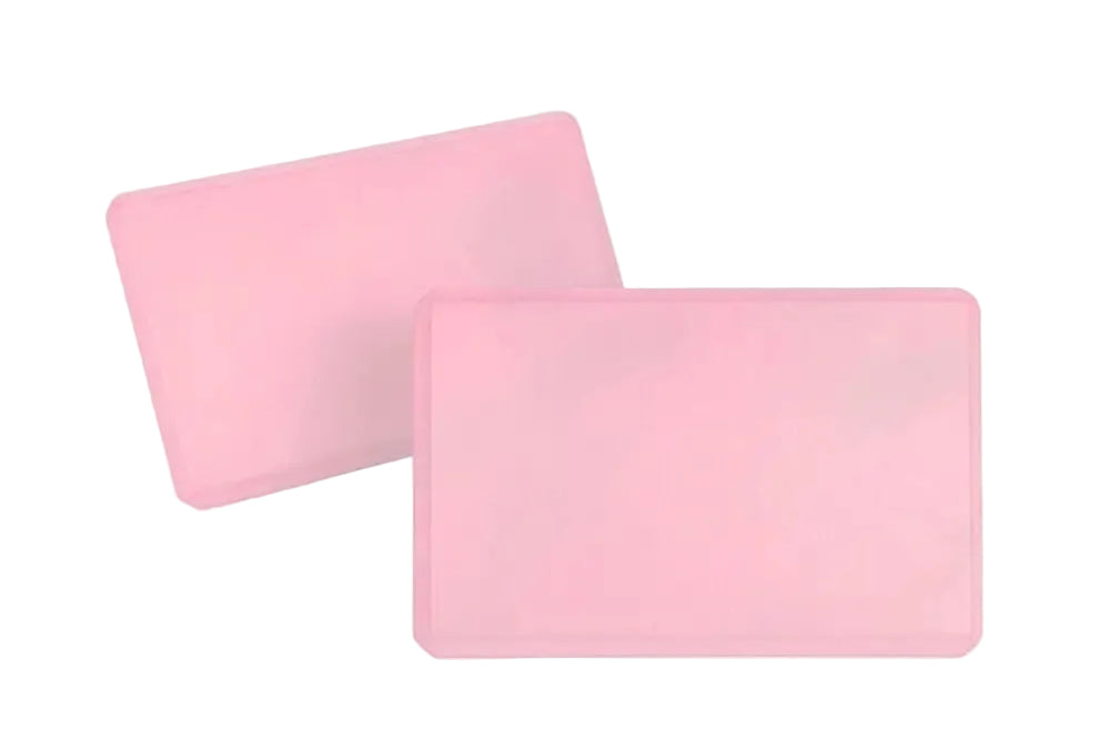 Two pink rectangular Yoga Blocks on a white background.
